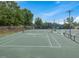 Well-maintained community tennis court featuring new nets and perimeter fencing at 9220 Meadow Mist Ct, Raleigh, NC 27617