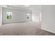 Large bedroom with carpet, tray ceiling, and windows at 4867 Pioneer Dr, Sanford, NC 27330