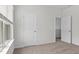 Bright bedroom with neutral walls, carpet and two doors, creating a serene living space at 4867 Pioneer Dr, Sanford, NC 27330