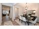 Elegant dining room featuring a modern chandelier, neutral walls, and seamless flow to other living spaces at 4867 Pioneer Dr, Sanford, NC 27330