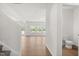 Hallway leading to the powder room, showcasing seamless flooring and abundant natural light at 4867 Pioneer Dr, Sanford, NC 27330