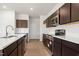 Bright kitchen featuring stainless appliances, modern lighting, and white countertops at 4867 Pioneer Dr, Sanford, NC 27330