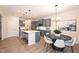 Bright kitchen features gray cabinets, island with seating, and modern lighting at 4867 Pioneer Dr, Sanford, NC 27330