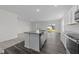 Kitchen island showcasing granite countertops, a stainless steel sink, and a view into the sunny backyard at 103 Gladstone Loop, Clayton, NC 27520