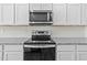 Modern kitchen featuring stainless steel appliances and granite countertops at 103 Gladstone Loop, Clayton, NC 27520