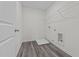 Functional laundry room with durable flooring, convenient utility connections, and storage rack at 103 Gladstone Loop, Clayton, NC 27520