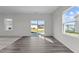 Bright living room with hardwood floors and sliding glass door to the backyard at 103 Gladstone Loop, Clayton, NC 27520