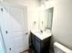 Bathroom vanity with gray cabinets, white countertop, and modern lighting at 107 Southern Estates Dr, Sanford, NC 27330