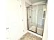Bathroom featuring a sliding glass shower door and neutral tile at 107 Southern Estates Dr, Sanford, NC 27330