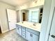 Bathroom featuring double sink vanity with a large mirror and modern lighting at 107 Southern Estates Dr, Sanford, NC 27330