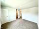 The main bedroom features two doorways with carpeted floors, neutral walls, and bright lighting at 107 Southern Estates Dr, Sanford, NC 27330