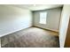 A bright bedroom with plush carpeting and a window overlooking the neighborhood at 107 Southern Estates Dr, Sanford, NC 27330