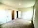 Bedroom with neutral carpet, white trim, and a large window at 107 Southern Estates Dr, Sanford, NC 27330