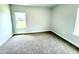 Neutral bedroom with carpet flooring and a large window letting in natural light at 107 Southern Estates Dr, Sanford, NC 27330