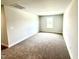 An empty bedroom features neutral walls, carpet, and natural light from a window at 107 Southern Estates Dr, Sanford, NC 27330