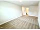 Spacious carpeted bedroom with light gray walls leading to the bathroom at 107 Southern Estates Dr, Sanford, NC 27330