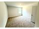 A bright bedroom with plush carpeting and a window at 107 Southern Estates Dr, Sanford, NC 27330