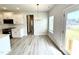 Bright breakfast nook featuring modern floors and a view of the adjacent kitchen and backyard at 107 Southern Estates Dr, Sanford, NC 27330