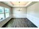 Dining room featuring luxury vinyl plank flooring, white trim, and large window at 107 Southern Estates Dr, Sanford, NC 27330