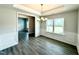 Dining room featuring luxury vinyl plank flooring, large windows, and white trim at 107 Southern Estates Dr, Sanford, NC 27330