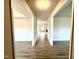 Hallway with luxury vinyl plank flooring and white trim throughout at 107 Southern Estates Dr, Sanford, NC 27330