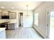 Bright eat-in kitchen with stainless steel appliances and gray cabinets at 107 Southern Estates Dr, Sanford, NC 27330