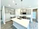 Kitchen featuring gray cabinets, white quartz countertops and stainless steel appliances at 107 Southern Estates Dr, Sanford, NC 27330