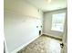 This laundry room includes tile floor, a window, and shelving at 107 Southern Estates Dr, Sanford, NC 27330