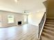 Spacious living area with luxury vinyl plank flooring and decorative fireplace at 107 Southern Estates Dr, Sanford, NC 27330