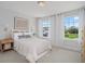 Cozy bedroom with neutral decor, a patterned bedspread, and large windows for natural light at 1107 Shovelhead Dr # Homesite 39, Durham, NC 27703
