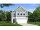 Charming two-story home featuring gray siding, a two-car garage, and a well-manicured lawn at 1107 Shovelhead Dr # Homesite 39, Durham, NC 27703