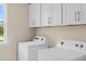 Well-lit laundry room with modern white washer and dryer units and ample storage at 1107 Shovelhead Dr # Homesite 39, Durham, NC 27703
