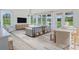 Airy living room with lots of windows, hardwood floors, and an adjacent dining area at 1107 Shovelhead Dr # Homesite 39, Durham, NC 27703