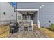 Charming backyard patio with comfortable lounge chairs and a grill, perfect for outdoor entertaining at 1136 Remey Ave, Wake Forest, NC 27587