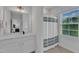 Bright bathroom featuring modern vanity, shower with curtain, and a window that brings in natural light at 1136 Remey Ave, Wake Forest, NC 27587