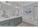 Modern bathroom featuring double vanity, soaking tub, and glass-enclosed shower, designed for comfort and style at 1136 Remey Ave, Wake Forest, NC 27587