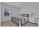 Cozy bedroom with a blue bed frame and matching end tables beside a window with neighborhood view at 1136 Remey Ave, Wake Forest, NC 27587