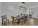 Formal dining room features a modern light fixture and large windows for natural lighting at 1136 Remey Ave, Wake Forest, NC 27587