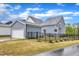 Charming two-story home with light blue siding, well-manicured lawn, and an attached garage, surrounded by a black fence at 1136 Remey Ave, Wake Forest, NC 27587