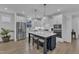 Modern kitchen features white cabinets, stainless steel appliances, and a large island with seating at 1136 Remey Ave, Wake Forest, NC 27587