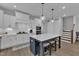 Modern kitchen featuring white cabinets, stainless steel appliances, and a spacious island with seating at 1136 Remey Ave, Wake Forest, NC 27587