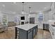 Open-concept living area featuring a fireplace, ample seating, and seamless flow into the kitchen at 1136 Remey Ave, Wake Forest, NC 27587