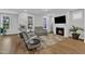 Bright living room features comfortable seating, a cozy fireplace, and large windows that let in natural light at 1136 Remey Ave, Wake Forest, NC 27587