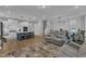 Open living space features a kitchen, living room, and dining area with a modern design and stylish finishes at 1136 Remey Ave, Wake Forest, NC 27587