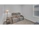 Comfortable movie room featuring reclining love seat, end table, and a window for natural light at 1136 Remey Ave, Wake Forest, NC 27587