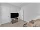 Entertainment space featuring a recliner loveseat, television, and easy access to a nearby bathroom at 1136 Remey Ave, Wake Forest, NC 27587