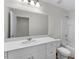 Well-lit bathroom featuring a vanity with ample storage, a large mirror, and a shower-tub combo at 1137 Solace Way, Rolesville, NC 27571