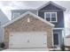 Two-story home featuring an attached two-car garage, brick facade, and charming curb appeal at 1137 Solace Way, Rolesville, NC 27571