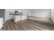 Open floor plan with a modern kitchen featuring stainless steel appliances and stone countertops at 1137 Solace Way, Rolesville, NC 27571