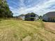 Expansive backyard view with newly built home and privacy fence in the distance at 119 Southern Estates Dr, Sanford, NC 27330